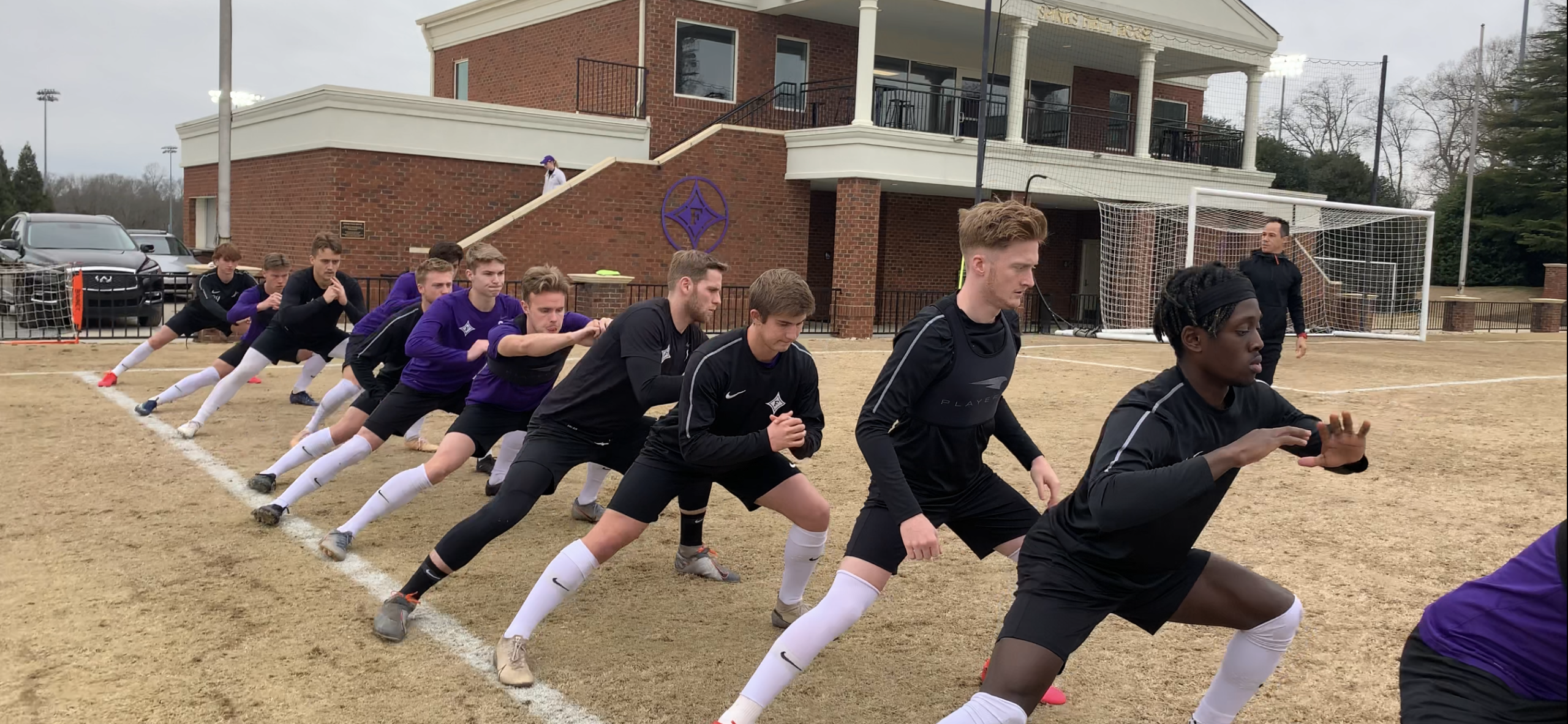Collegiate soccer players performing movement preparation and performance training as part of a soccer performance consulting program.